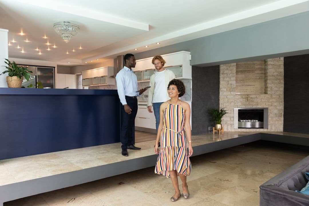 An agent showing a property to prospective buyers